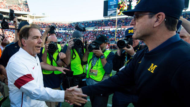 Jim harbaugh and Nick saban shake hands